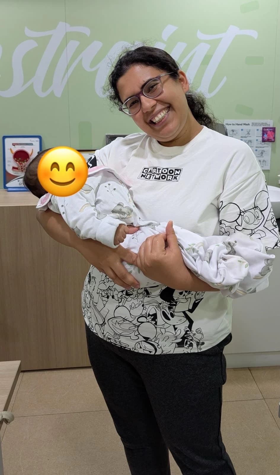 Dr. Anjani Dixit laughing as she holds a newborn at the clinic