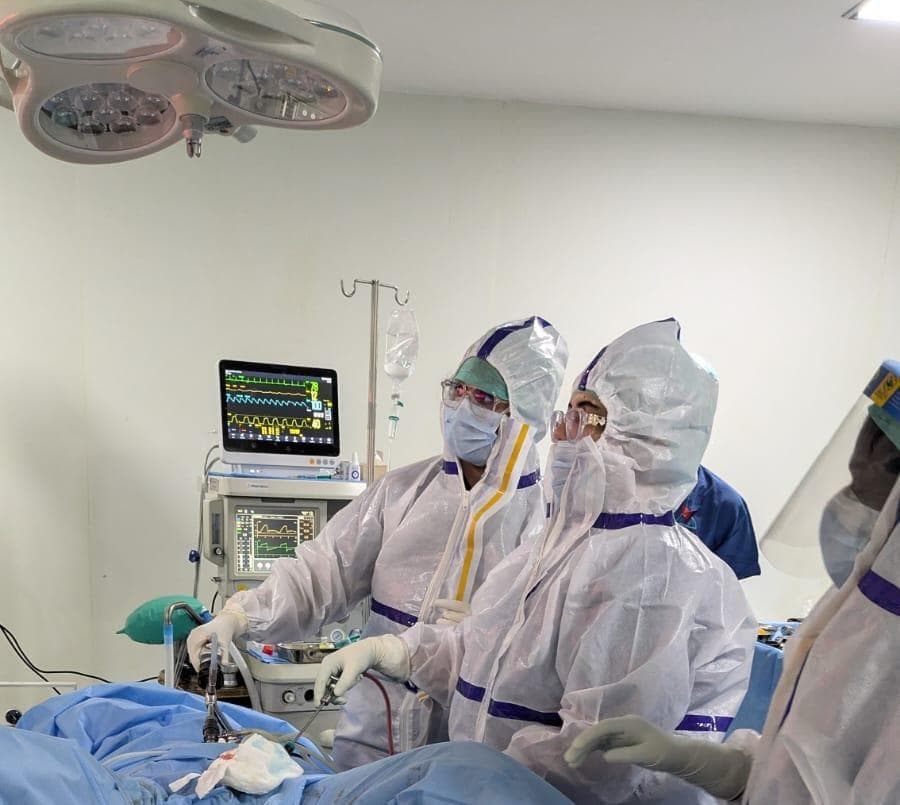 The theatre team in full protective gear during a procedure