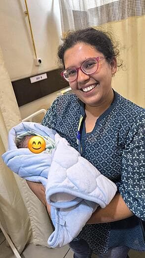 Dr. Anjani Dixit with a newborn in the ward after delivery
