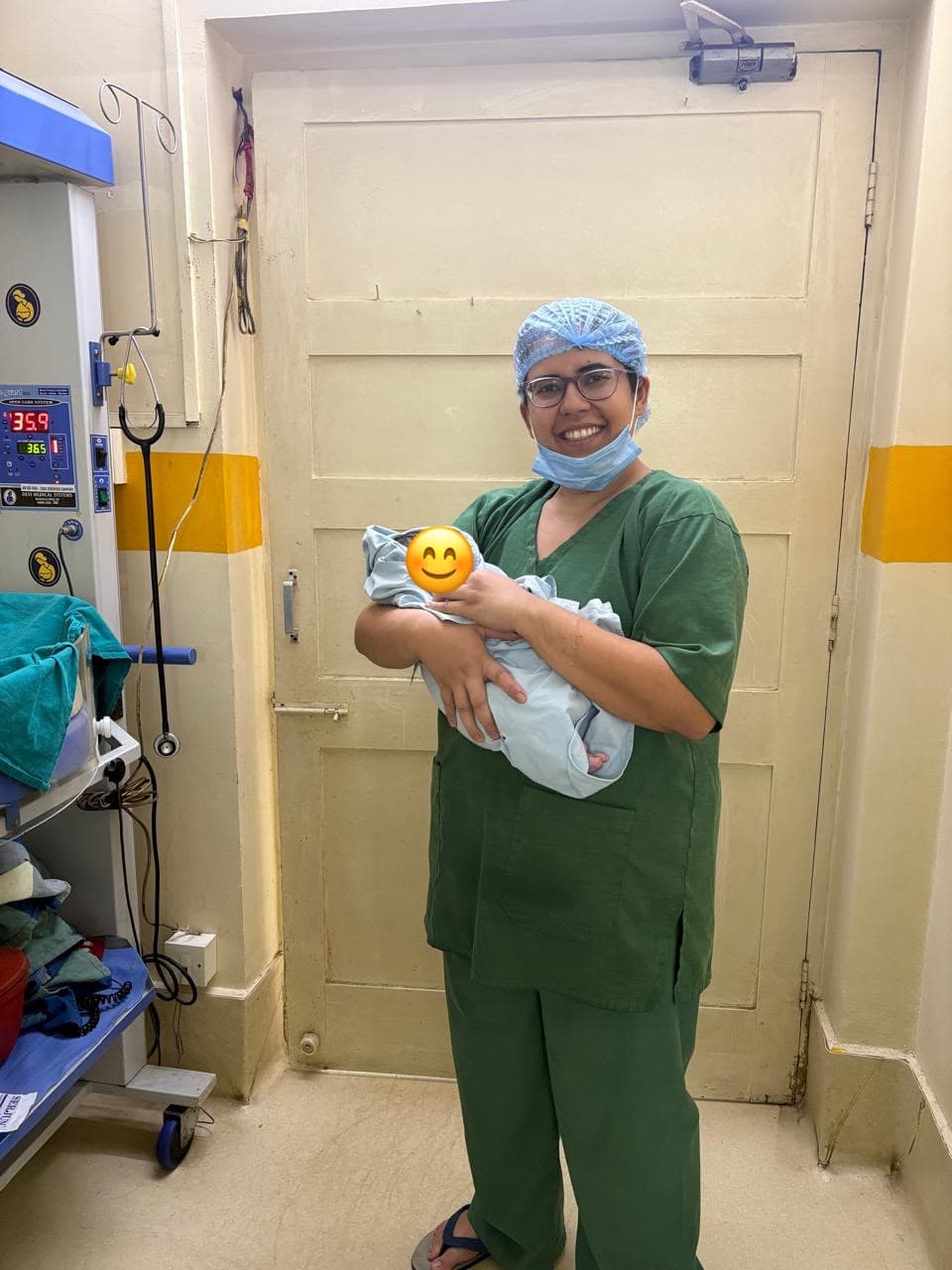 Dr. Anjani Dixit in the newborn care unit holding a swaddled baby