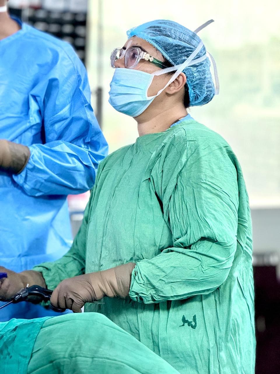 Dr. Anjani Dixit performing laparoscopic surgery, watching the monitor